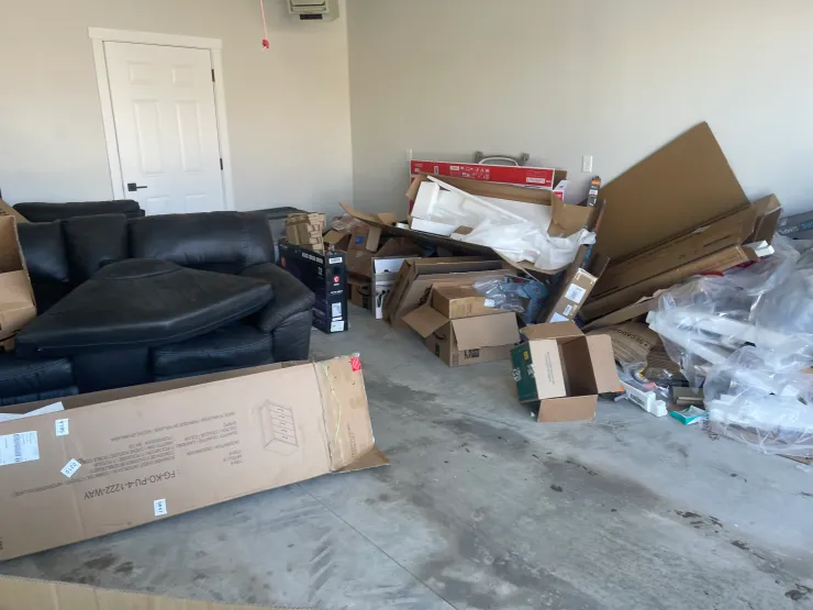 Garage cleanout with furniture and boxes before removal in Williston ND