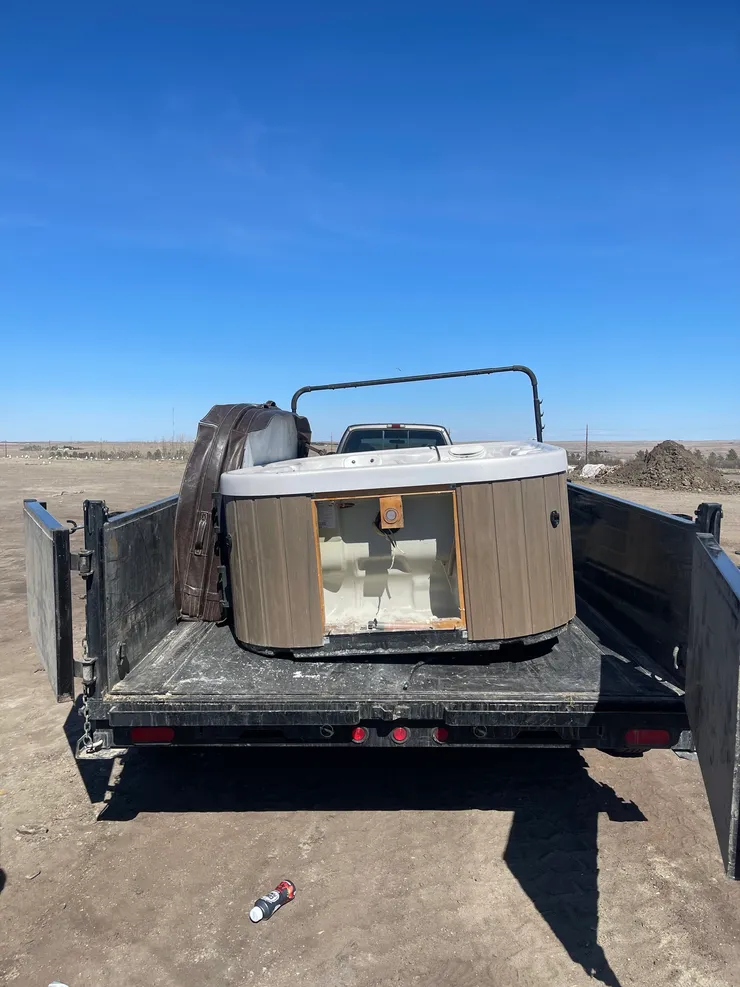 Hot tub loaded onto junk removal trailer in Williston ND