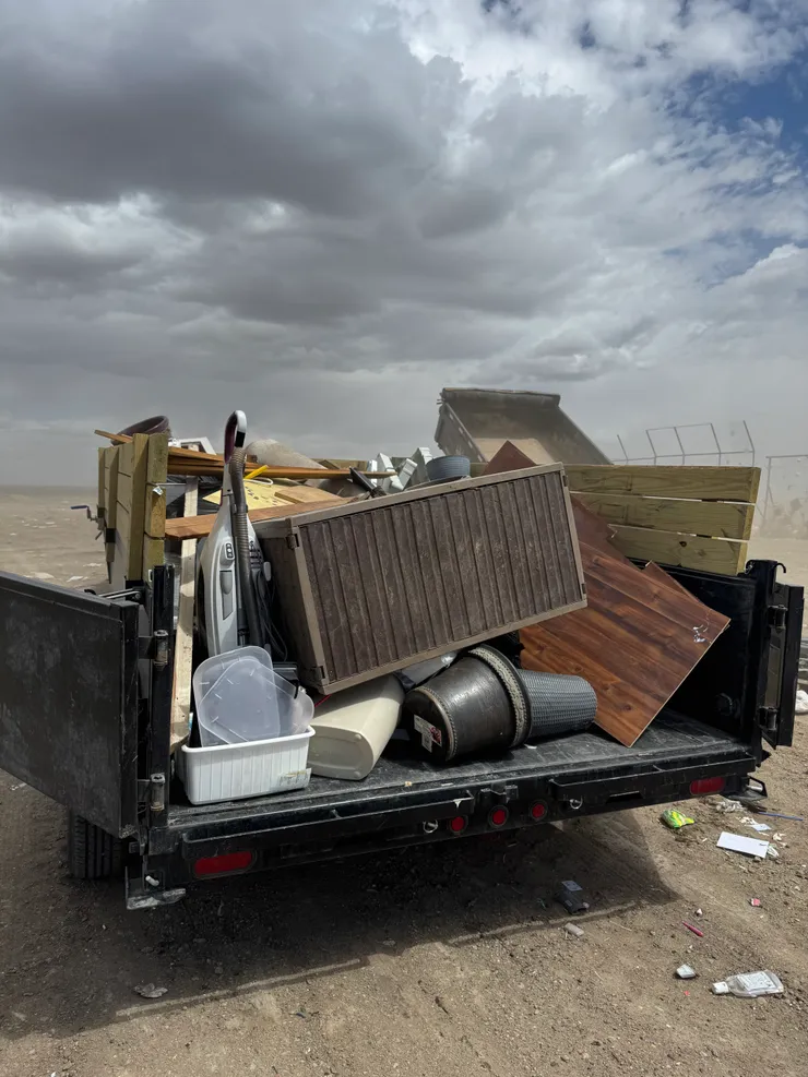 Loaded junk removal trailer hauling furniture and household items